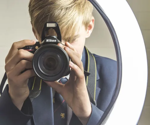 Student using a DLSR to take photos