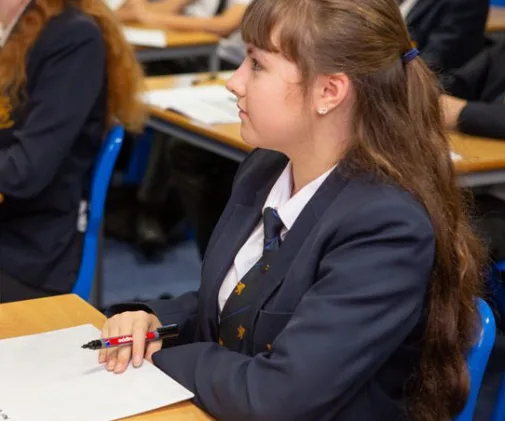 Student taking notes in class